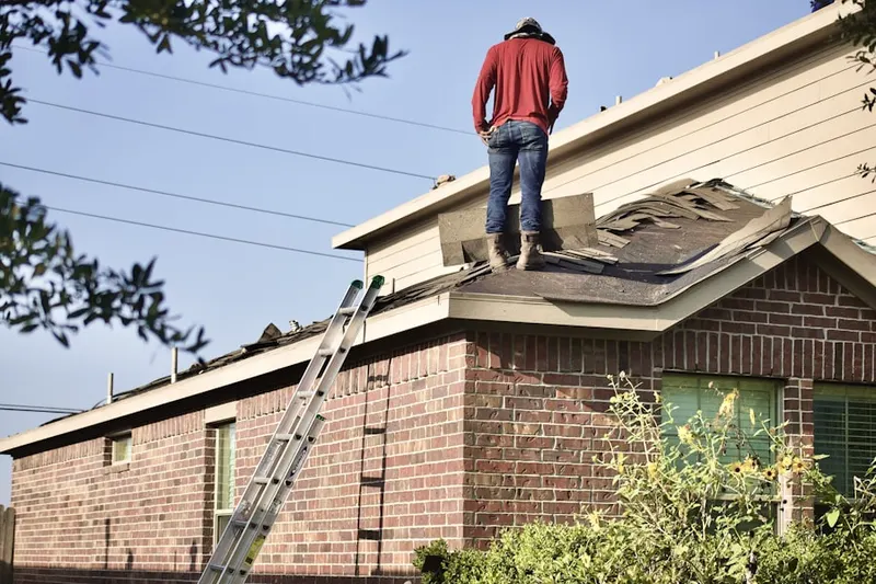 Professional roofer working on a residential roof in Pasco West